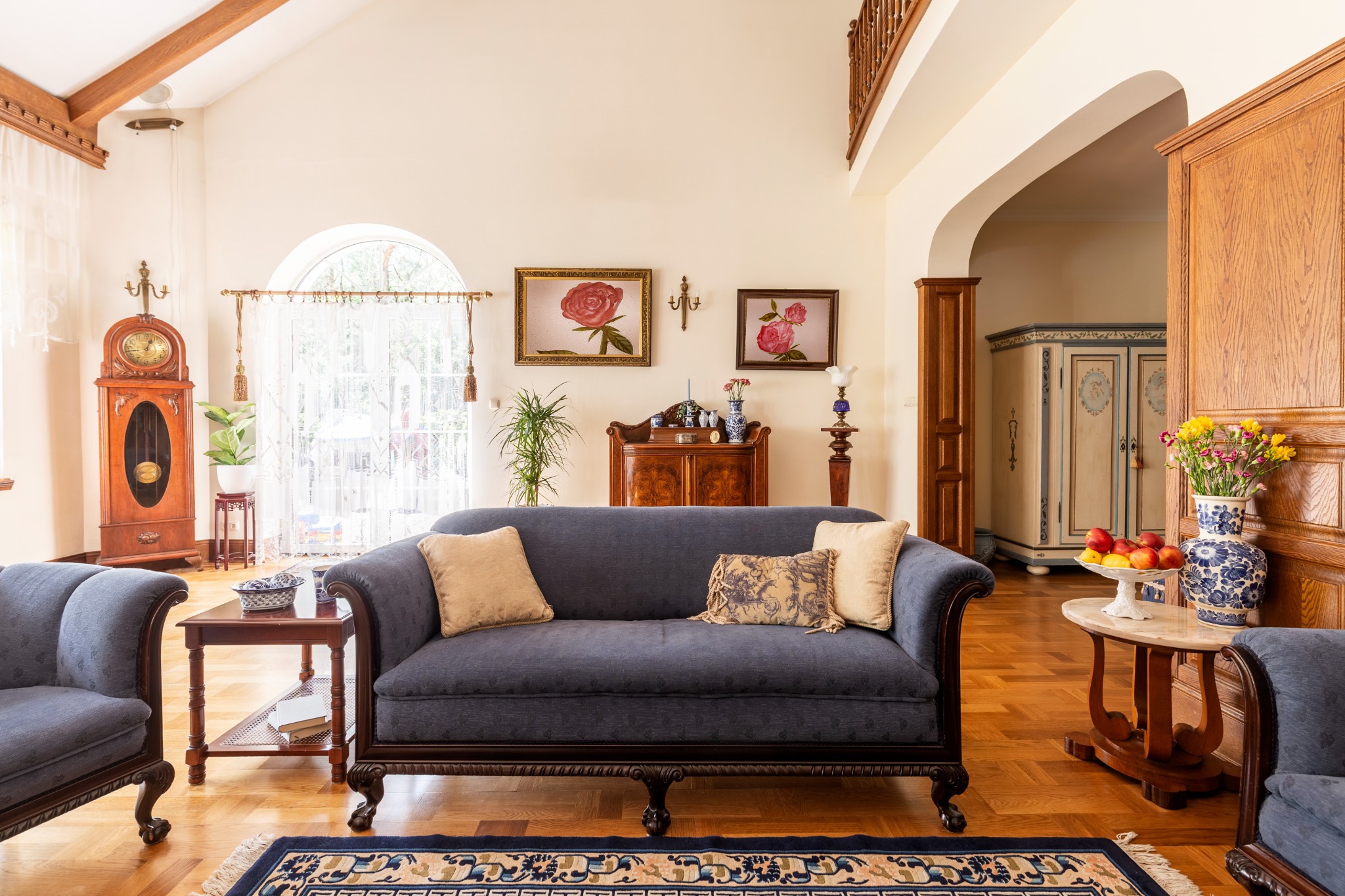 Warm, carefully furnished living room with collected art and decorative objects